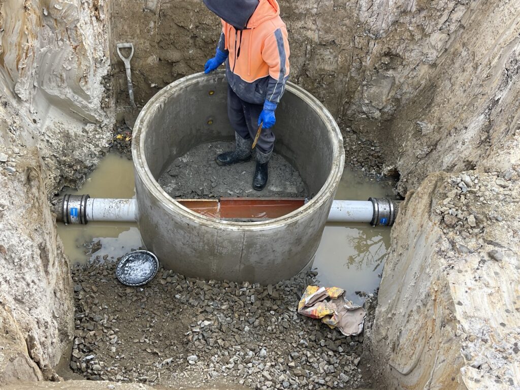 Precast concrete manhole being installed