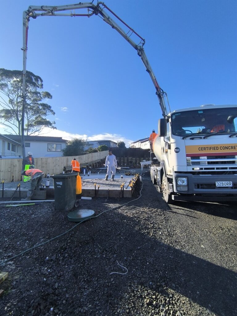 Concrete pump placing a foundation slab