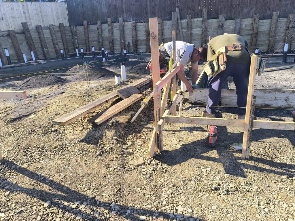 Workers setting foundation boxing and formwork