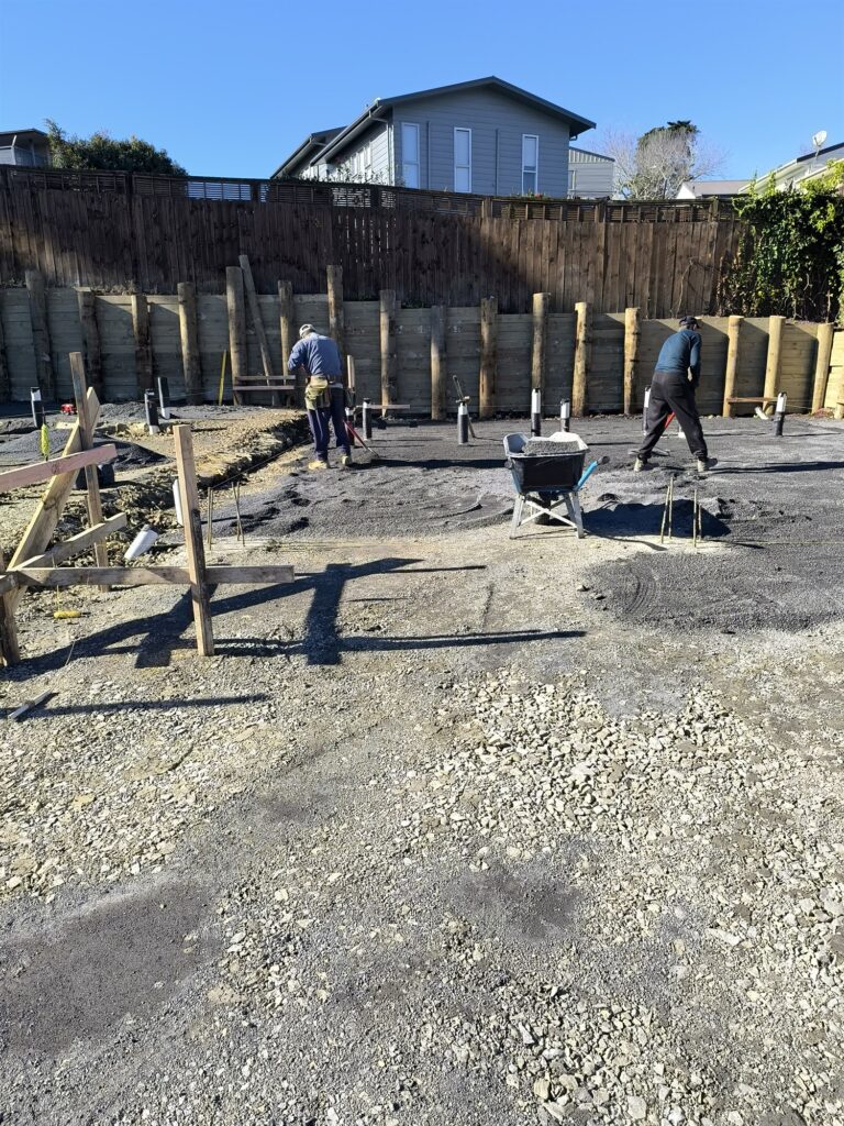 Completed timber pole retaining wall